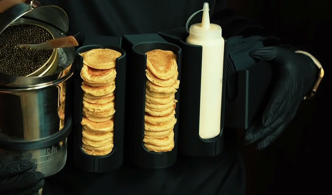 Blini stacks and an open caviar tin staged on a TheVtaste roaming service tray